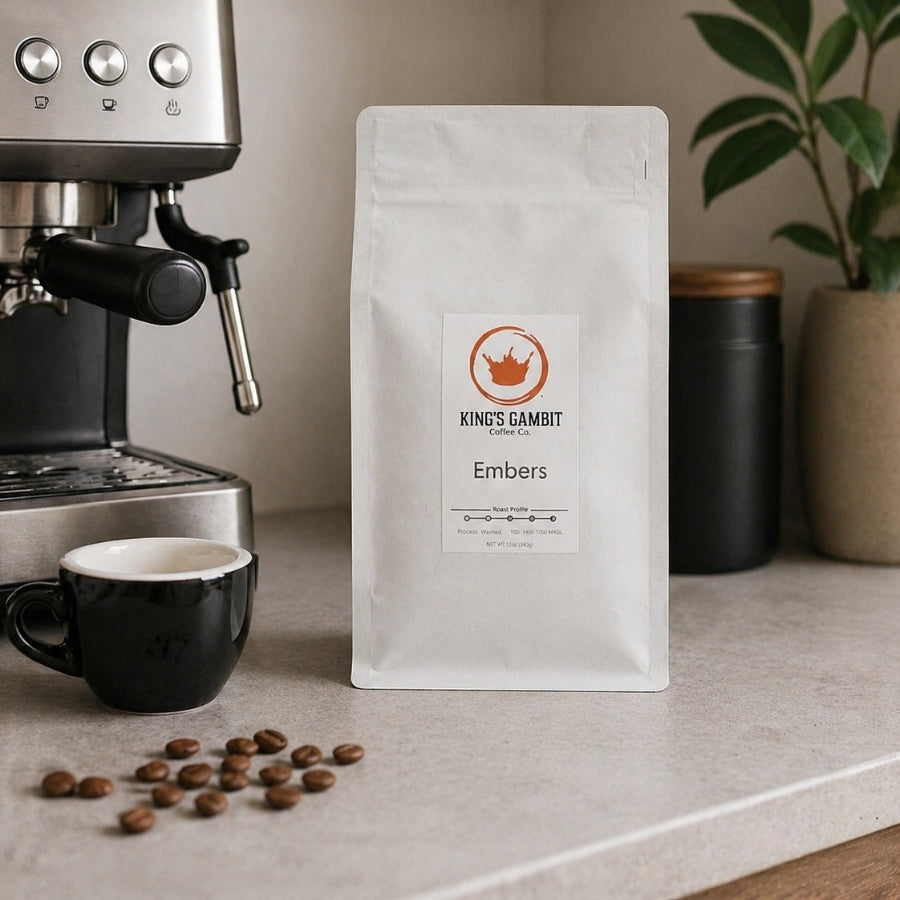 Bag of King's Gambit Coffee Embers Organic Dark Roast Blend coffee with dark, rich roasted beans in a resealable package.